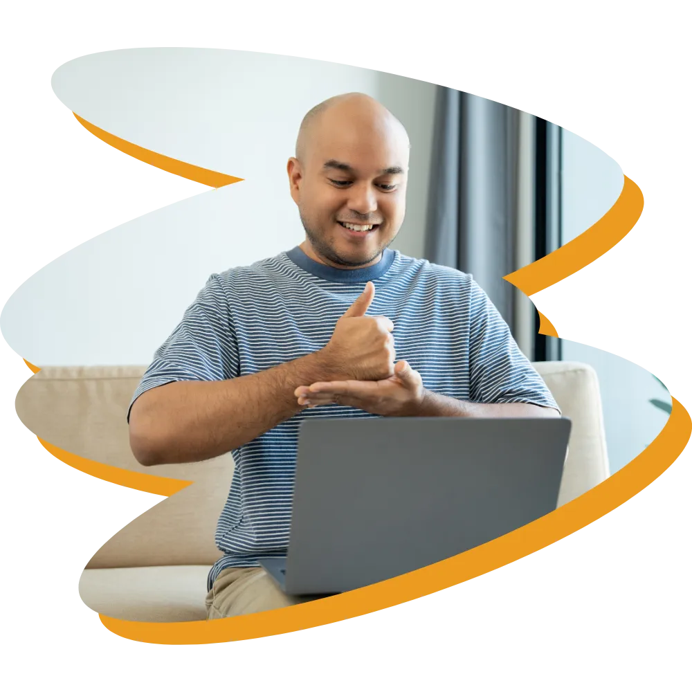 Deaf man looking at laptop and communicating via sign language
